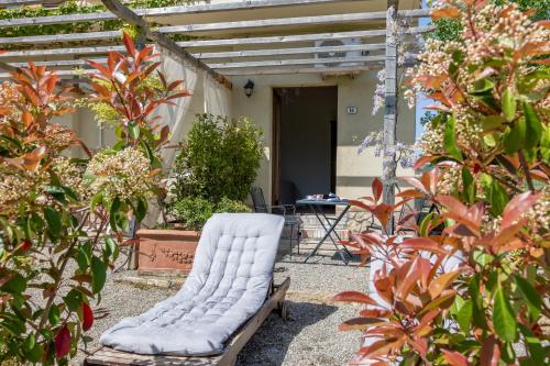 a white chair sitting in the middle of a garden at Agriturismo San Marcello in Castiglione dʼOrcia