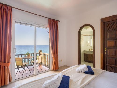 a bedroom with a bed and a view of the ocean at Altamar 60 Balcony beach views By CanariasGetaway in Playa del Aguila