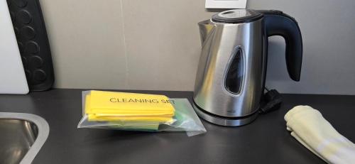 a container of yellow butter on a counter next to a toaster at Apartamentos Turisticos Paraiso in Funchal