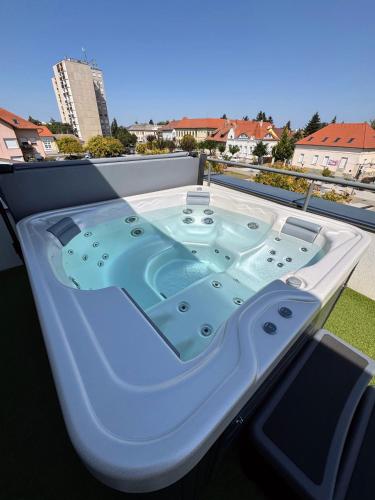 a jacuzzi tub sitting on top of a balcony at Neo Premium Apartments in Sárvár