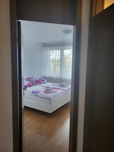 a bedroom with a bed in a room with a window at Ferienwohnung Kris in Leipzig