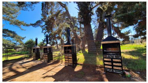 a group of bird cages in front of a fence at Algarrobo playa Canelo Cabaña opción Tinaja in Algarrobo