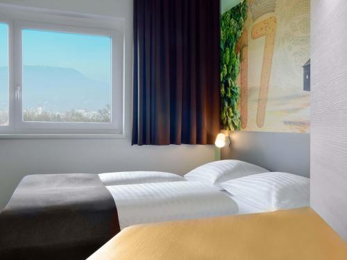 Una cama o camas en una habitación de B&B Hotel Graz City-Süd