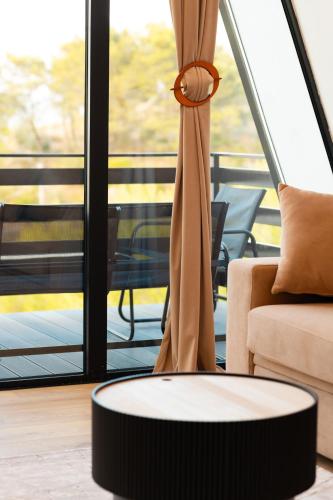 a coffee table in a living room with a window at Lakeside Villas in Široka
