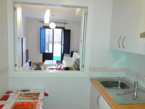 a kitchen with a mirror and a sink and a living room at COSTA TROPICAL & ALPUJARRAS Relaxation in Vélez de Benaudalla