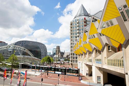 a city with a building with yellow triangles on it at DoubleTree by Hilton Rotterdam Centre in Rotterdam