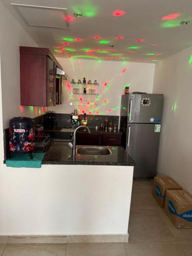 a kitchen with a sink and a refrigerator at Oyster bey in Marsa Alam