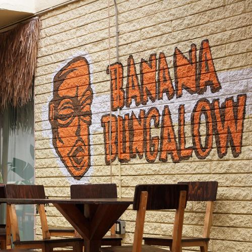 a sign on the side of a building that says island kingdom at Banana Bungalow West Hollywood Hotel & Hostel in Los Angeles