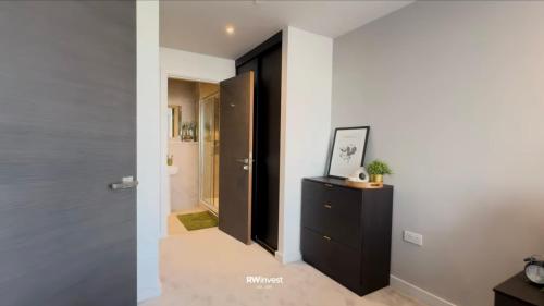 a hallway with a black door and a black cabinet at old in Manchester
