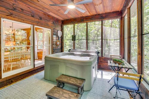 a bathroom with a large tub in a room with windows at North Georgia Cabin with Hot Tub and Community Perks! in Jasper