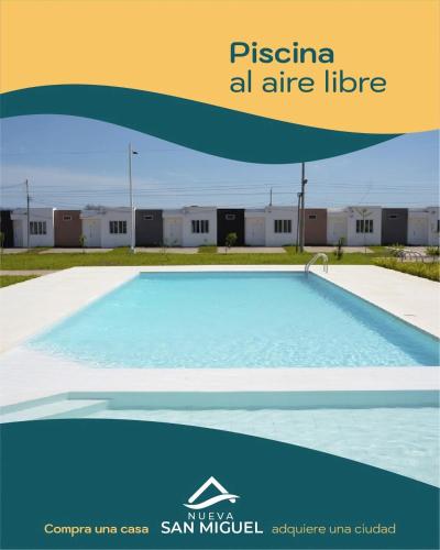 a picture of a swimming pool in front of a building at la casita de Daniela in San Miguel