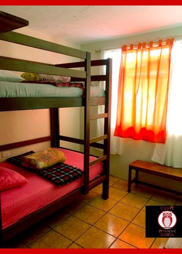 two bunk beds in a room with a window at Athene Moon in Juivi