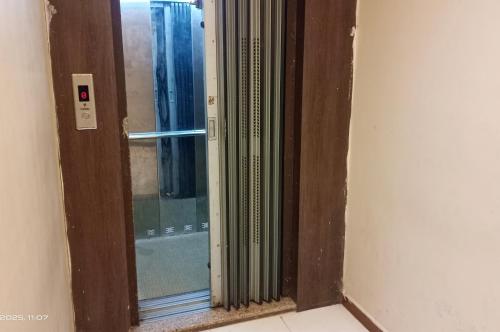 a glass door with a window in a room at Hotel Radhika in Somnath