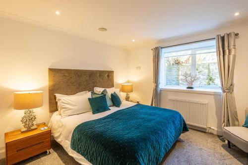 a bedroom with a large bed and a window at The Merchants House in Pittenweem
