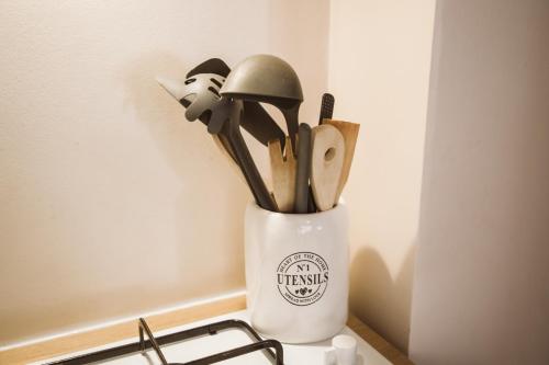 a container of utensils sitting on top of a counter at as maison in Terni