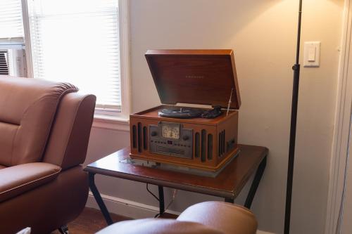 an old radio sitting on a table next to a couch at Florence in Milford