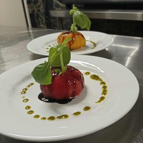 two plates of food with an apple on a table at La Sapinière St Lary Soulan in Saint-Lary-Soulan