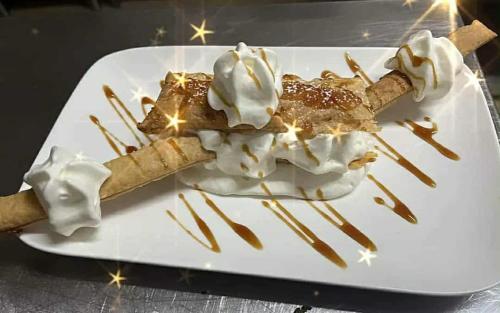 a white plate with two desserts on a table at La Sapinière St Lary Soulan in Saint-Lary-Soulan