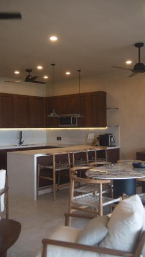 a kitchen with a table and a counter top at Minimalist elegance by the beach in Zihuatanejo