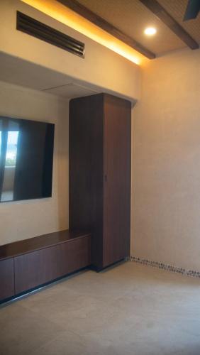 a room with a door and a television on the wall at Minimalist elegance by the beach in Zihuatanejo