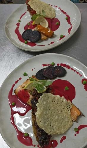 two plates of food sitting on a table at La Sapinière St Lary Soulan in Saint-Lary-Soulan
