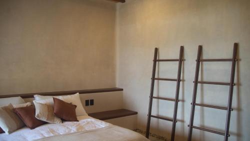 a bedroom with a bed with two shelving at Minimalist elegance by the beach in Zihuatanejo
