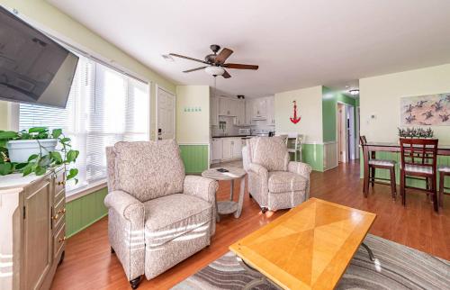 a living room with two chairs and a table at K1410 Loggerhead Landing - Oceanside Condo Just Steps to the Beach! in Croatan Shores
