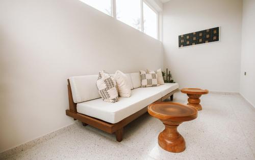 a living room with a white couch and a window at AnoMansa Beach Resort at Elmina Bay in Elmina