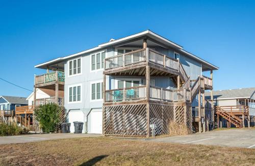 a large white building with balconies on it at K1410 Loggerhead Landing - Oceanside Condo Just Steps to the Beach! in Croatan Shores