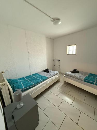 a room with two beds and a table in it at Spacious Apartment in Mörfelden-Walldorf in Mörfelden-Walldorf