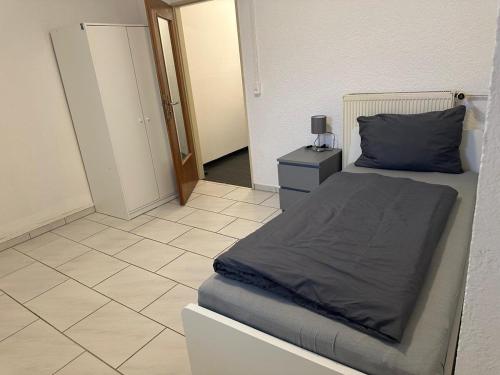 a bedroom with a bed and a tiled floor at Spacious Apartment in Mörfelden-Walldorf in Mörfelden-Walldorf
