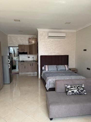 a bedroom with a bed and a couch at nador city courniche in Nador
