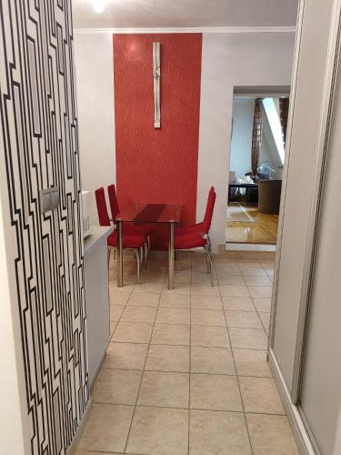 a kitchen and dining room with a table and chairs at CentrumRoom in Hévíz