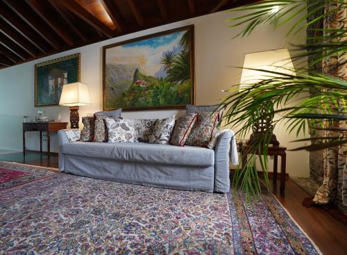 a blue couch in a living room with a rug at Modern Luxury Canarian House in Garachico
