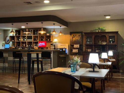 a restaurant with tables and chairs and a bar at Segovia Sierra de Guadarrama in Los Ángeles de San Rafael