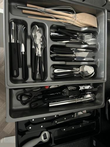 a drawer filled with cooking utensils and other items at Tyne Relaxation in Newcastle upon Tyne