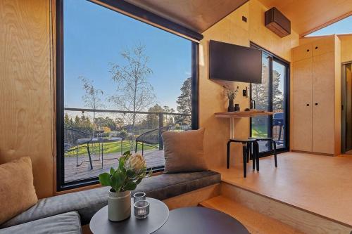 a living room with a large window in a house at Tiny Grace - Boutique Yarra Valley Accommodation in Healesville