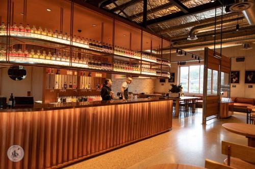 two people standing at a bar in a restaurant at Tiny Grace - Boutique Yarra Valley Accommodation in Healesville