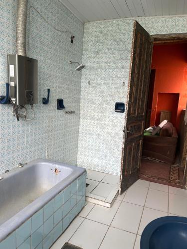 a bathroom with a bath tub in a room at Pousada Charqueada Costa do Abolengo in Pelotas