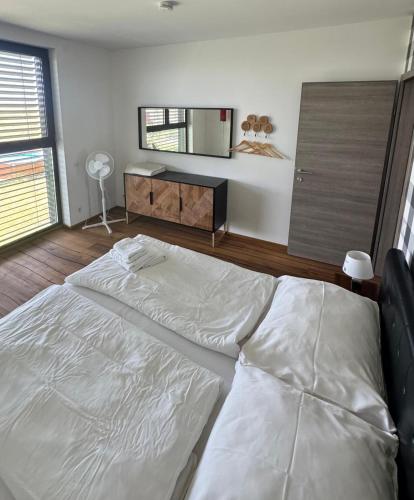 a bedroom with a large white bed in a room at das Haus in Jois in Jois