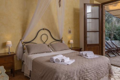 a bedroom with a bed with towels on it at Agriturismo San Marcello in Castiglione dʼOrcia