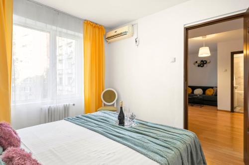 a bedroom with a bed with a blue blanket at Stepup Apartment, Downtown Bucharest, City Center, Garden View in Bucharest
