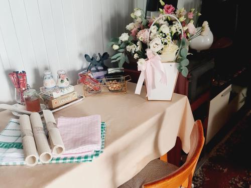 a table with a vase of flowers on it at Seoski dom in Šavnik