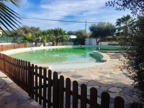 a large swimming pool with a fence around it at Villa Carlos in Vinaròs