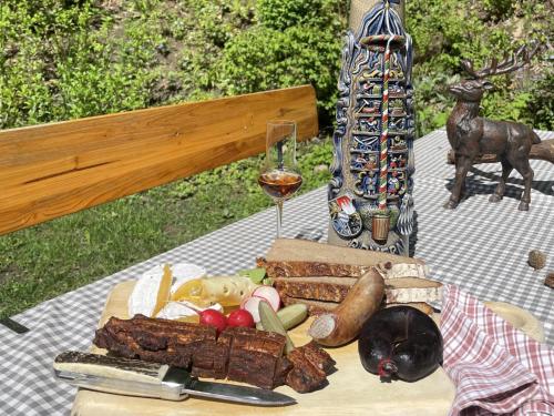 a table with a plate of food and a dog on it at Landhaus Bez II in Weißenbrunn