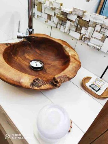 a wooden sink sitting on top of a counter at Beach apartment, Ti Clé de Lo in Pointe-Noire