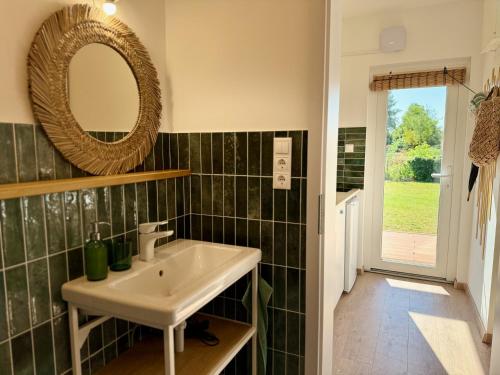 a bathroom with a sink and a mirror at Tisza-Tavi Nyaralósziget - Just a few steps from the peaceful shores of Lake Tisza in Tiszafüred