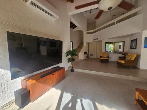 a living room with a large flat screen tv on the wall at King's Place Cancun Hotel Zone in Cancún