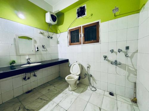 a bathroom with a toilet and a sink and a shower at Blue Vista Homestay in Guwahati