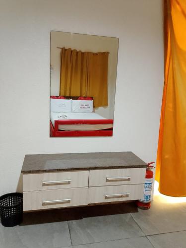 a mirror above a dresser in a room at Wjv Inn Talamban in Cebu City